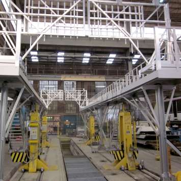 Onderhoudsplatforms voor treinwagons op pilaren Industrieel platform voor toegang tot daken van treinwagons in een spoorwegwerkplaats.